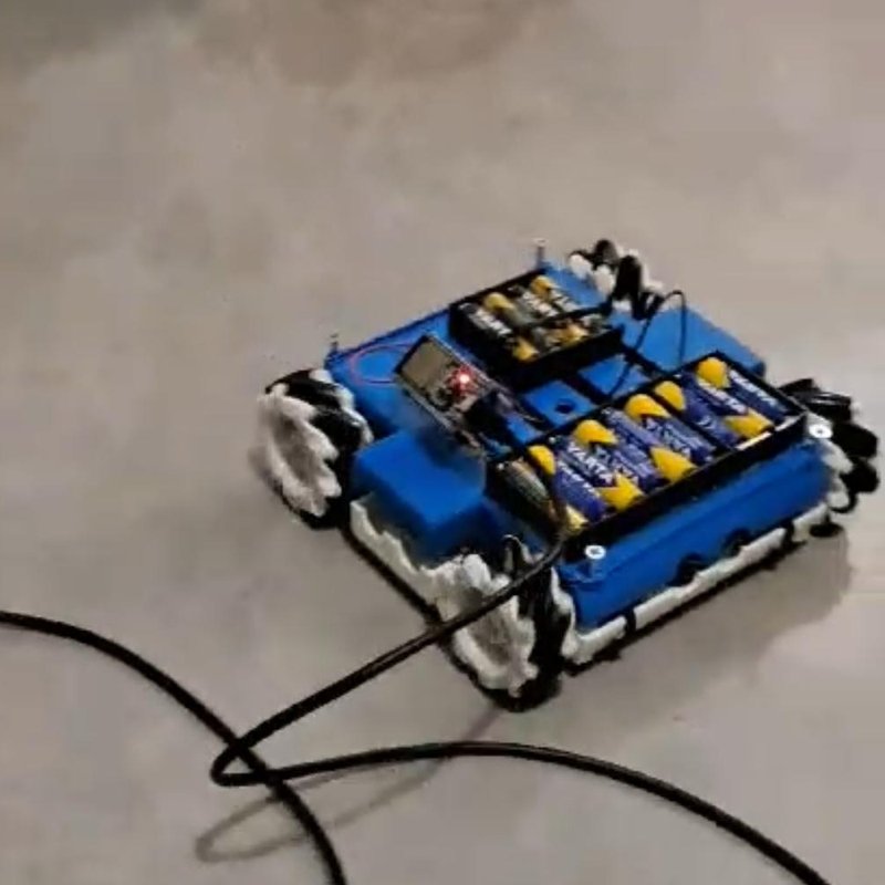 Drawing robot with a blue 3D-printed chassis, mecanum wheels, microcontroller board and battery packs